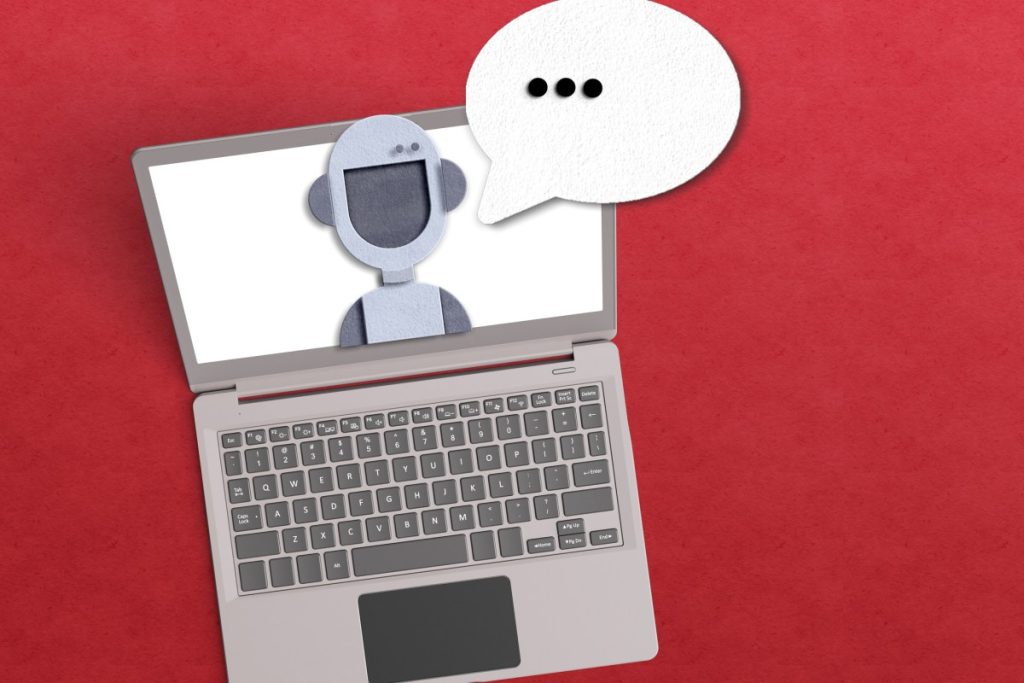 Voice AI engine and OpenAI partner LiveKit hits $1B valuation AI agent concept with robot inside a laptop with a voice bubble on red background.