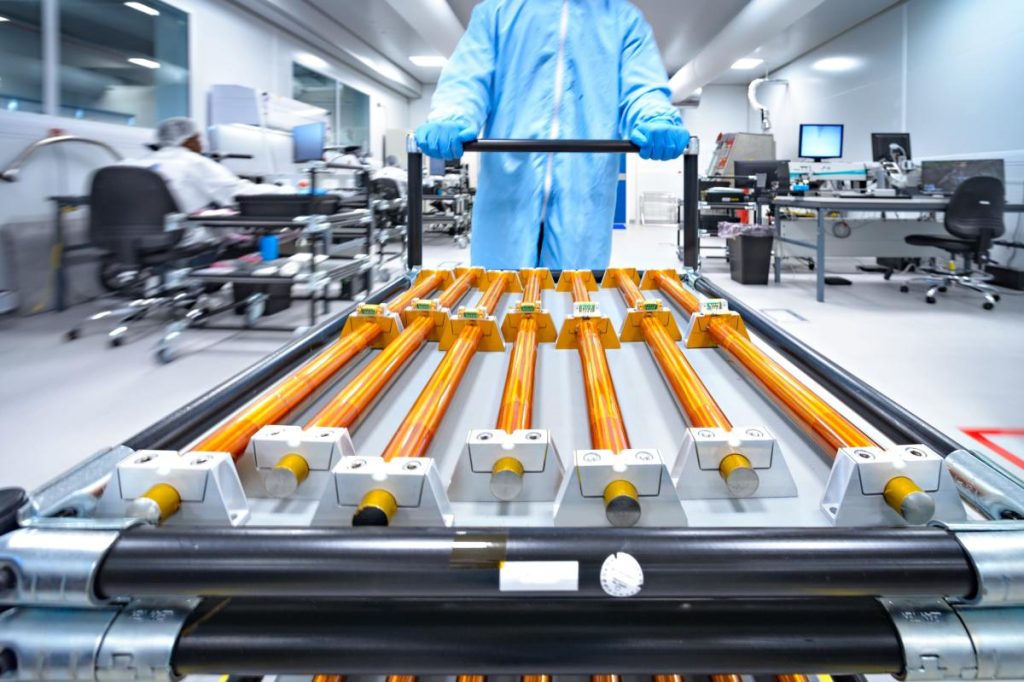 Copper rods being moved on a cart.