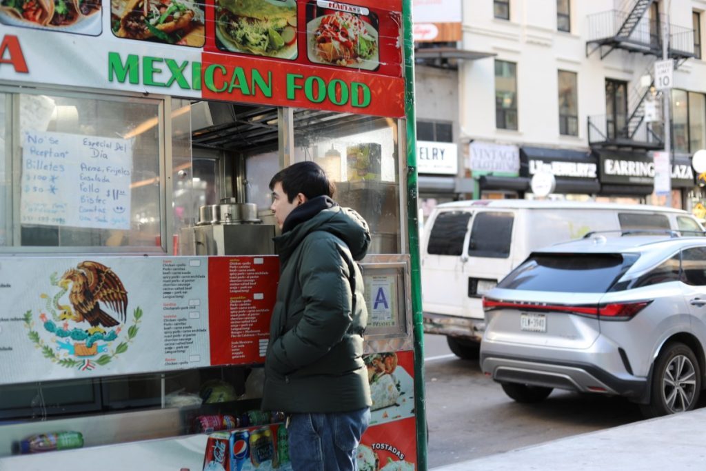 How PopWheels helped a food cart ditch generators for e-bike batteries A man places an order at a Mexican food cart.