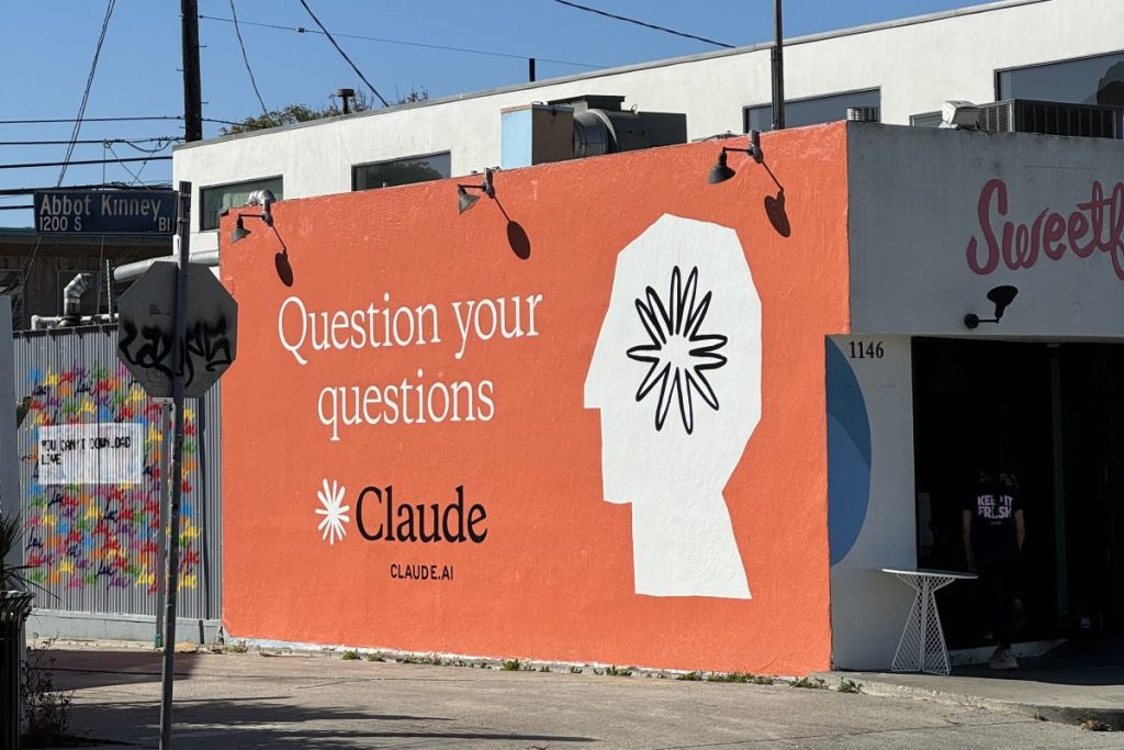 Claude ad on side of building
