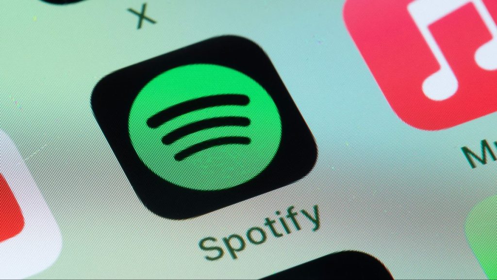 Spotify’s new feature lets you explore the story behind the song you’re listening to Spotify, Apple Music on smart phone screen.