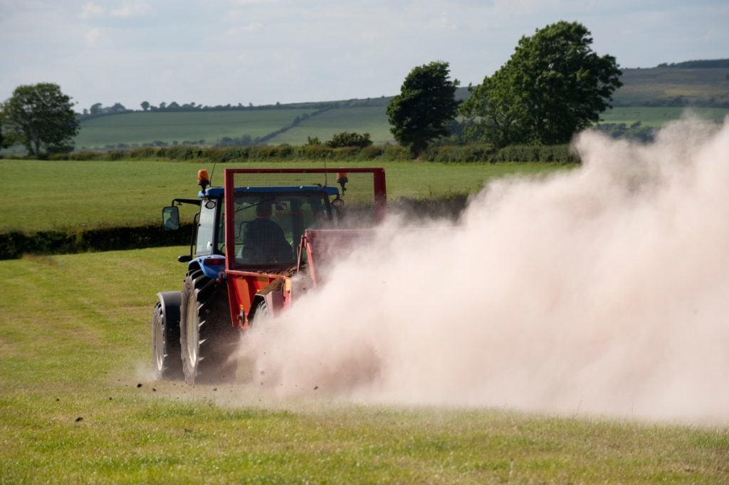 Google and Microsoft-backed Terradot acquires carbon removal competitor Farmer spreading chicken manure mixed with lime on newly harvested meadow