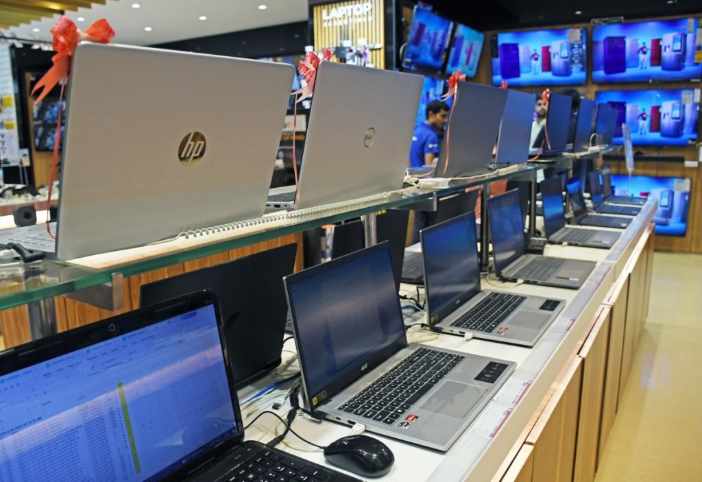 Laptops of different brands are kept on display at Vijay Sales electronic store.
