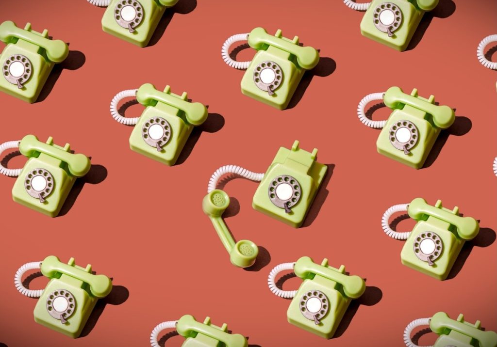 Let’s take a look at the retro tech making a comeback High angle view of some vintage green rotary telephones arranged on a brown background, showcasing retro communication technology with a nostalgic and artistic flair