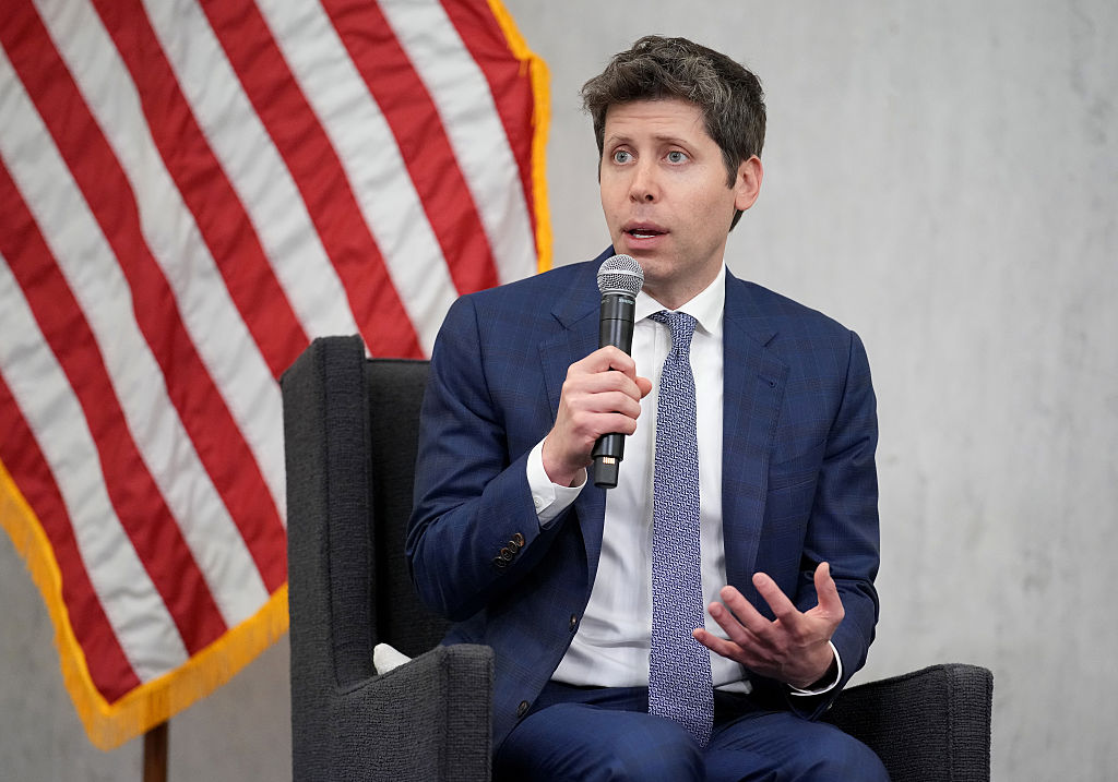 OpenAI’s vision for the AI economy: public wealth funds, robot taxes, and a four-day workweek Sam Altman, CEO of OpenAI, sitting in front of American flag