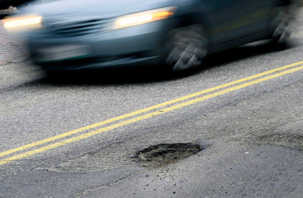 Potholes cost cities millions: This company is using AI and trucks to fix them CAPE ELIZABETH, ME - FEBRUARY 22: A car drives past a pothole on Forest Ave. in Portland Tuesday, February 22, 2022. (Shawn Patrick Ouellette/Portland Press Herald via Getty Images)
