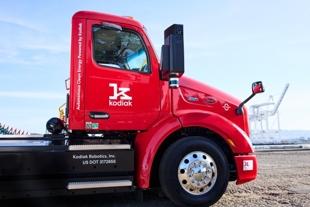 Kodiak AI raises $100M at a steep discount, sending its stock tumbling 37% Cab of red Peterbilt semi truck