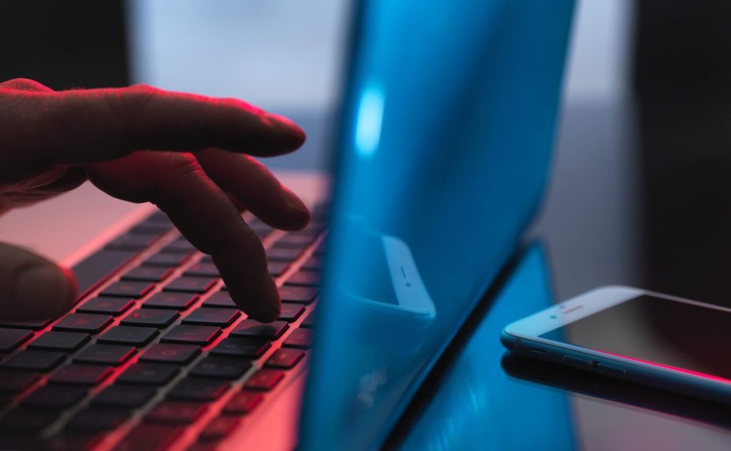 Man typing on a laptop.