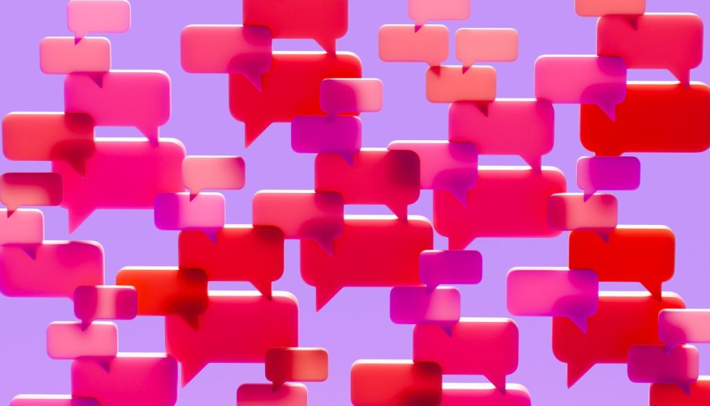 UK may ban social media for children under 16 Conceptual image of a dense cluster of three-dimensional speech bubbles in shades of pink red and magenta overlapping and filling the visual field against a solid vibrant purple background.