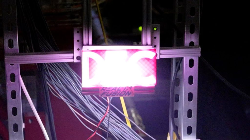 Realta Fusion generates electricity directly from a fusion reaction, an apparent first A sign that says DEC is lit with purple backlighting.