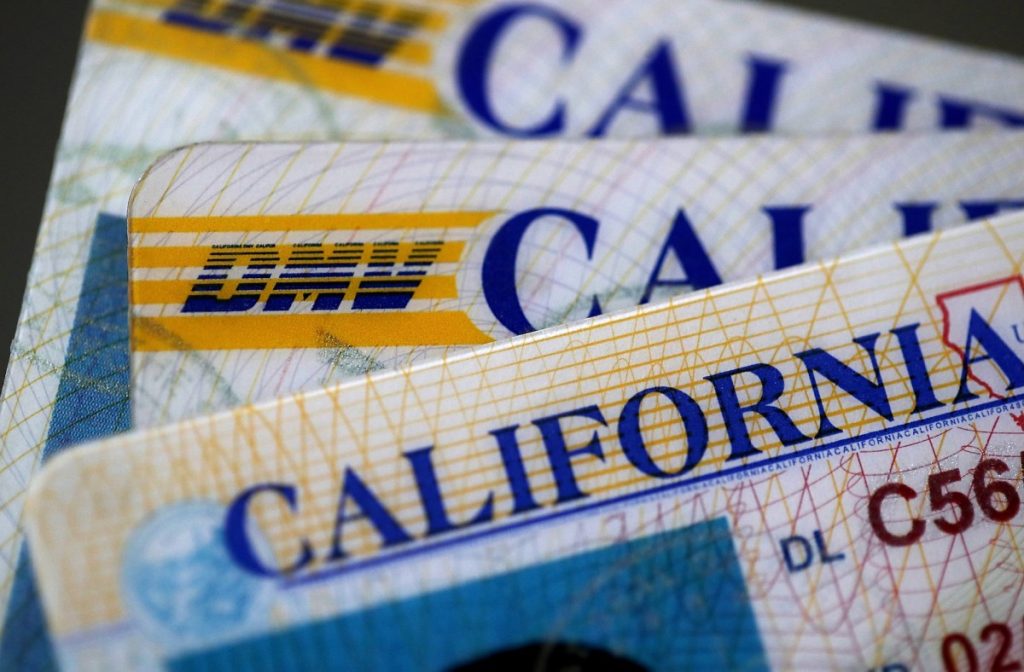 SAN ANSELMO, CA - MAY 09: In this photo illustration, the California Department of Motor Vehicles (DMV) logo appears on a California driver license on May 9, 2017 in San Anselmo, California. The California Department of Motor Vehicles is being accused in a federal lawsuit of violating voter federal "motor voter" law with a requirement for over 1 million residents who renew their license by mail to fill out a seperate form with their renewal. (Photo Illustration by Justin Sullivan/Getty Images)